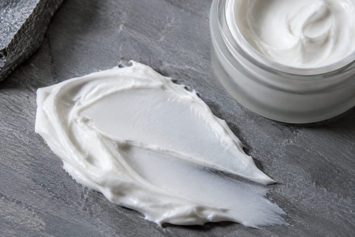 Velvety barrier face cream textured on slate stone exhibiting micro-emulsion quality